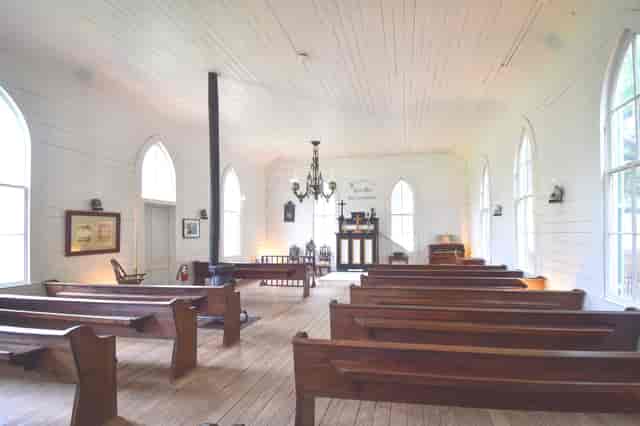 Charming rustic Bandstand venue with arched windows, ideal for weddings and gatherings.