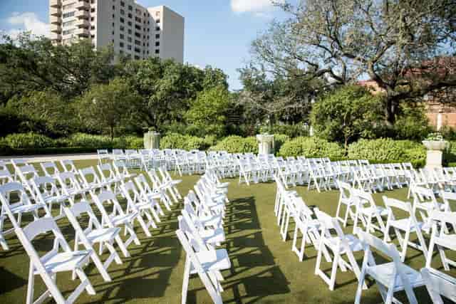 Outdoor wedding seating in Celebration Garden, McGovern Centennial Gardens, lush greenery backdrop.