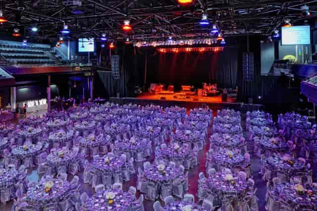 Main Hall at Bayou Music Center set for a formal banquet with purple tablecloths.