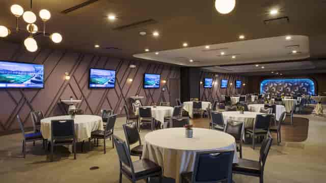 Event space at Topgolf Houston - Katy with round tables, ideal for corporate gatherings.