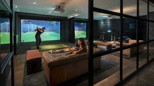 Modern lounge with golf simulator at Topgolf Houston - Katy for corporate retreats.