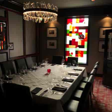 Elegant private dining room with stained glass, ideal for corporate events and intimate gatherings.