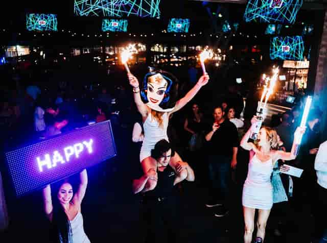 Vibrant corporate event with dynamic lighting and LED performers at Pour Behavior.