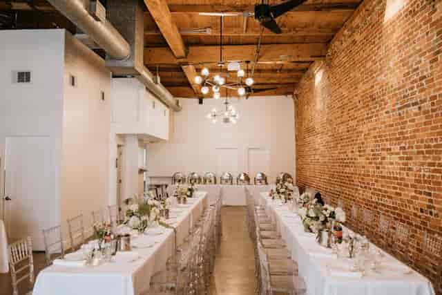 Elegant event space with long tables, floral centerpieces for formal dinners and networking.