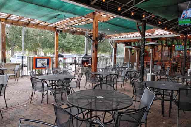 Outdoor event space at SpindleTap Brewery with rustic charm and shaded pergola.