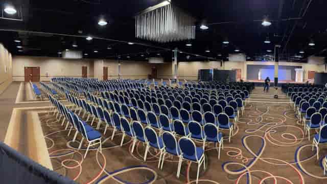 Spacious ULH Event Center ballroom with blue chairs for conferences and seminars.