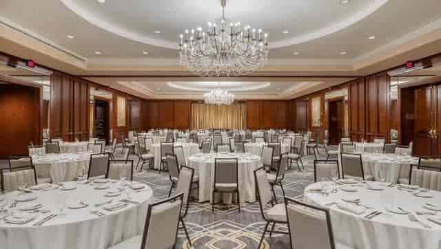 Elegant River Oaks banquet hall with round tables, perfect for corporate events and celebrations.