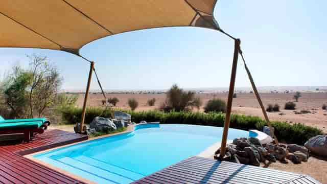 Al Majlis Boardroom with pool at Al Maha Resort, ideal for luxury events and meetings.