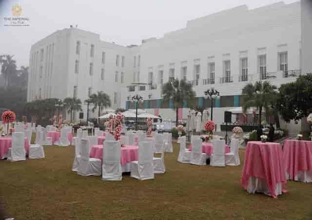 Elegant outdoor event space at The Imperial Lawn, featuring white tables with pink accents.