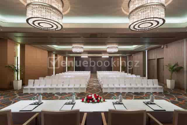 Elegant banquet hall with modern chandeliers for conferences and formal gatherings.