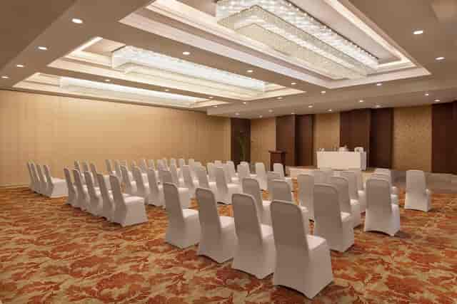 Meeting room at Ramada by Wyndham, white chairs for corporate events and meetings.