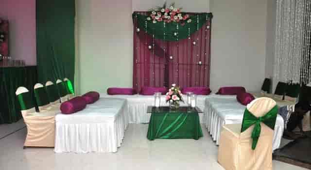 Elegant Banquet Hall at Hotel Regent Grand, with green and burgundy decor for events.