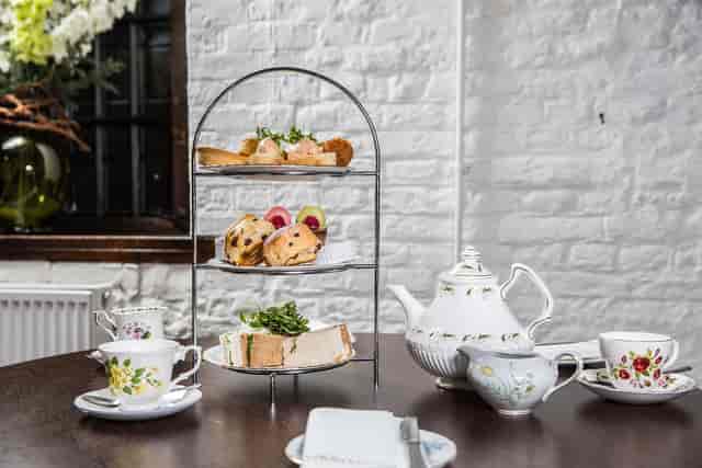 Elegant afternoon tea setup at Moat Terrace, Tudor Barn Eltham for events and gatherings.