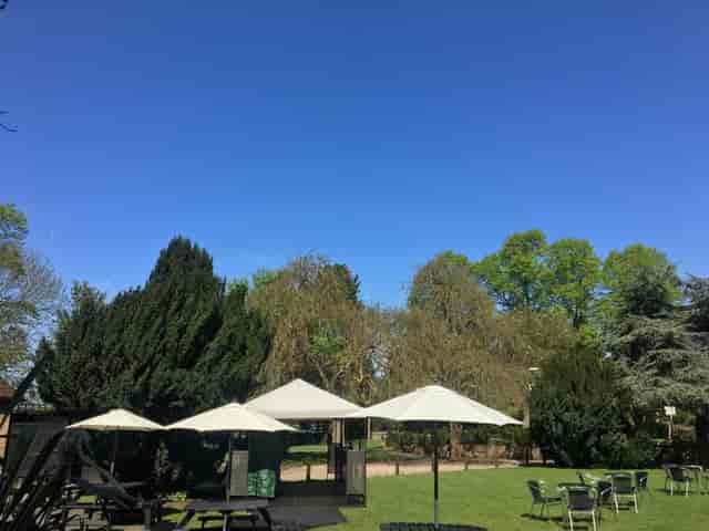 Serene Tudor Barn Eltham front lawn venue with lush greenery for outdoor events.