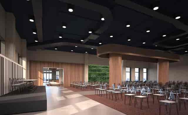 Spacious ballroom venue with large stage, ideal for conferences and networking events.