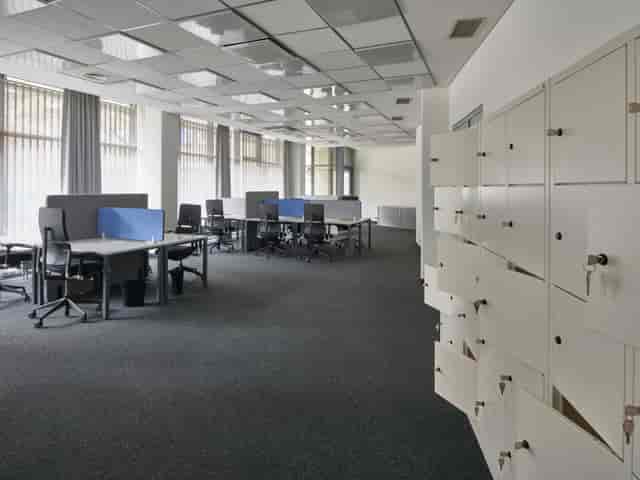 Modern coworking space with ergonomic workstations for meetings and training events.