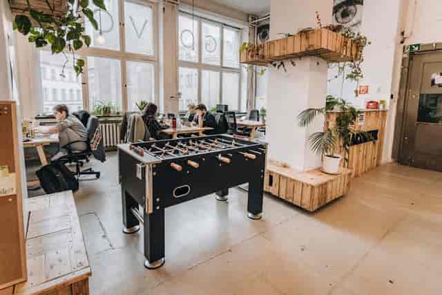 Modern coworking space with foosball table, ideal for creative meetings and networking.