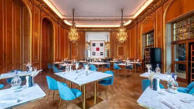 Elegant restaurant event space with wooden paneling, ideal for upscale gatherings.