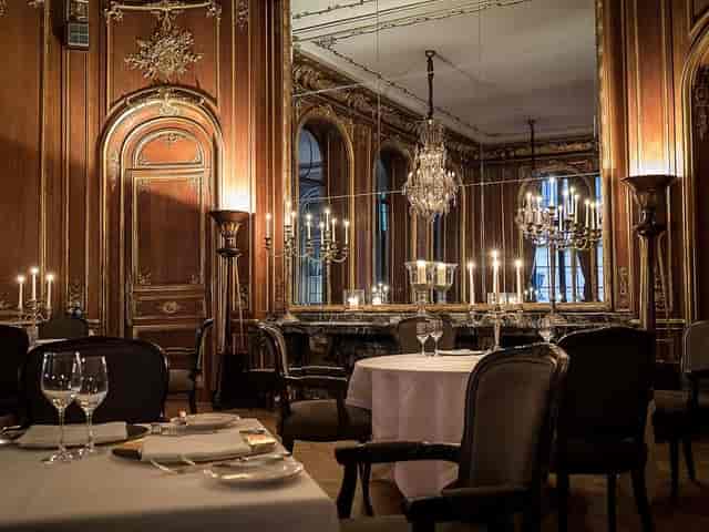Elegant dining space with ornate mirrors at Historical Wintergarten, Schlosshotel Berlin.