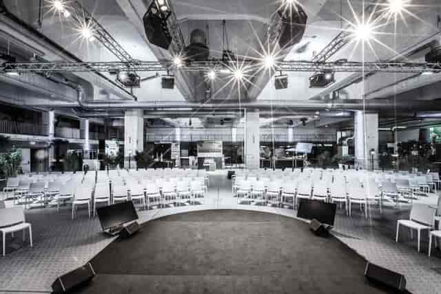 Function room in Tek Dream Event with central stage for conferences and presentations.