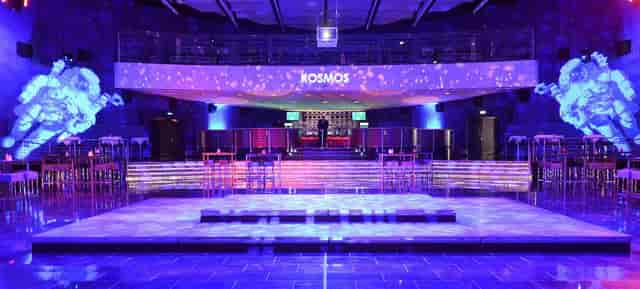 Saal 1 at KOSMOS: modern event space with elevated stage for corporate gatherings.