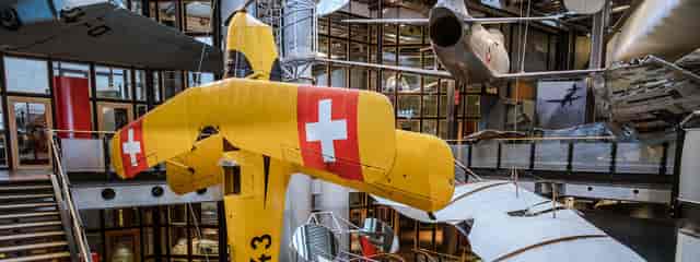 Vibrant yellow Swiss aircraft at Deutsches Technikmuseum Berlin, perfect for corporate events.