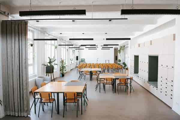 Versatile tasting room for workshops, presentations, and networking events with natural light.