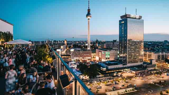 Vibrant rooftop event space with skyline views, perfect for networking and social gatherings.