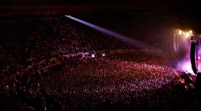 Packed concert hall with vibrant lighting for live events and gatherings.