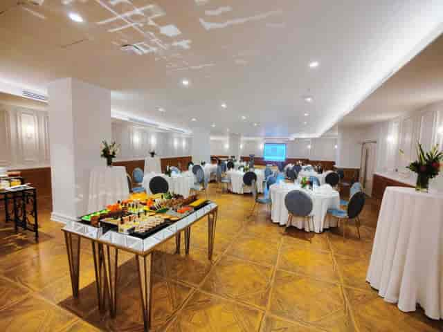 Elegant meeting space at Nishat Hotel, featuring round tables for corporate events.