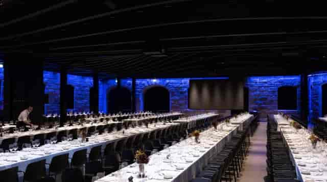 Sophisticated event space in Villa Copenhagen with elegant long tables for corporate gatherings.