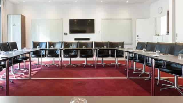 Meeting room 3+4 in Copenhagen Island, featuring a large table and modern tech for conferences.