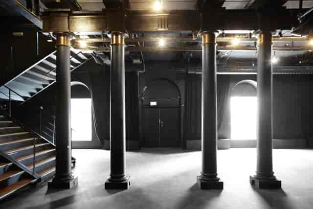 Elegant event space in Pumpehuset with grand columns, ideal for meetings and showcases.