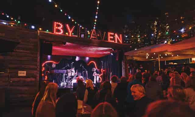 Outdoor event space at Byhaven in Pumpehuset, featuring a lit stage and vibrant community vibe.