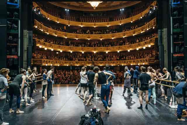 Bustling theater rehearsal at Det Kongelige Teater, showcasing staging and engagement.