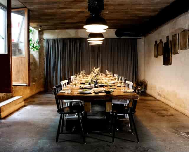 Private dining room with a long wooden table, perfect for corporate dinners and gatherings.