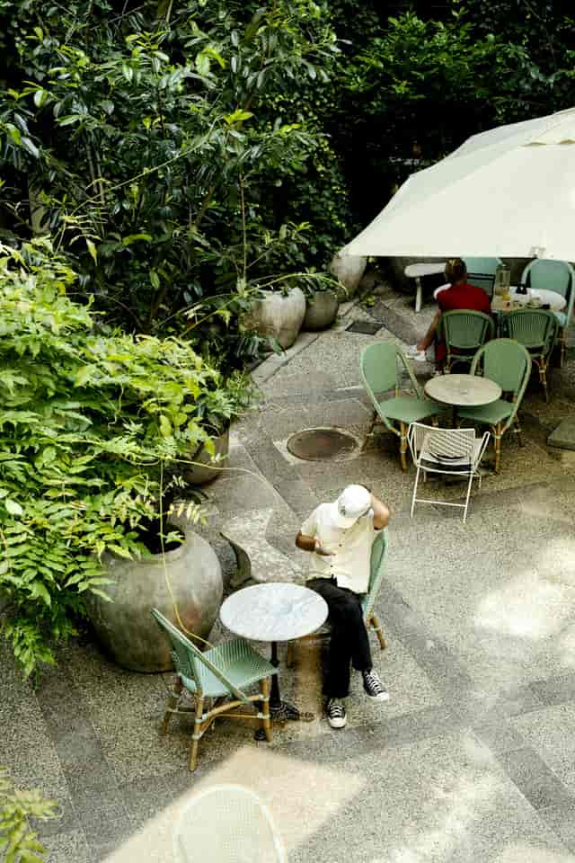 Coco Hotel courtyard with lush greenery, ideal for casual meetings and networking events.