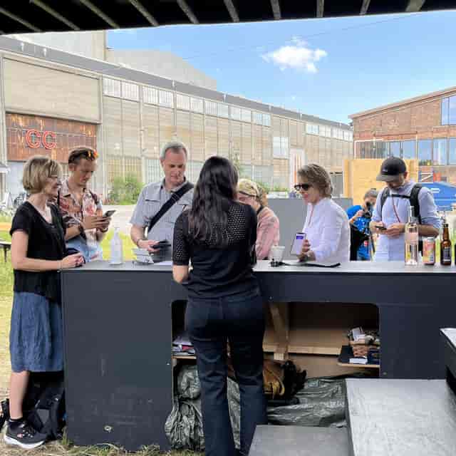 Diverse group at a workshop check-in station, promoting networking and community engagement.