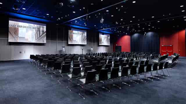 Spacious corporate conference room with dual screens for presentations and workshops.
