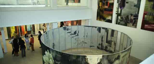 Modern exhibition space with circular installation, ideal for creative events and art showcases.