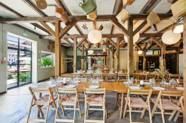 Spacious venue with wooden beams, perfect for meetings and events at BaneGaarden.