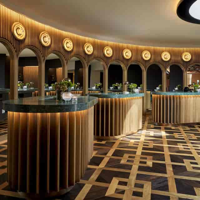 Sophisticated meeting room with curved wooden arches for elegant events and networking.