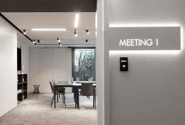 Modern shared kitchen meeting room in KPM Hotel for corporate events and strategy sessions.