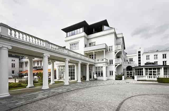 Elegant Nordic event venue in Kurhotel Skodsborg with grand entrance, perfect for upscale meetings.