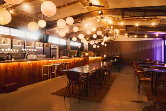 Stylish Kødbyen event space with warm lighting, ideal for gatherings and networking.