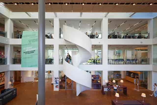 Modern multi-level event space with a spiral staircase for conferences and gatherings.