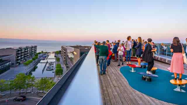 Vibrant rooftop event at Experimentarium with sunset views, ideal for outdoor gatherings.