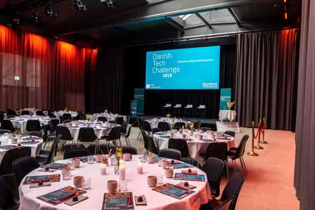 Event space at Centralen, round tables set for Danish Tech Challenge networking.