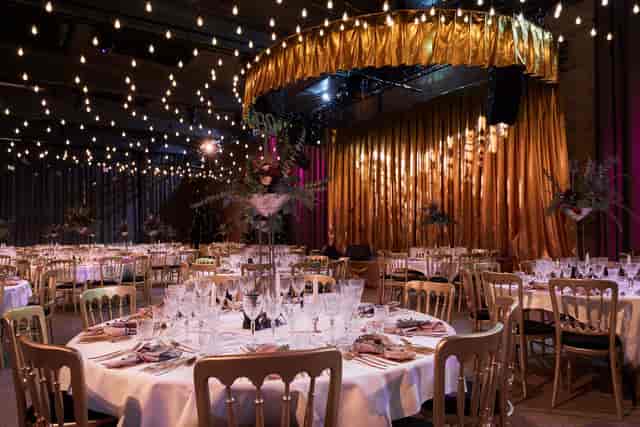 Elegant dinner event space at Centralen, featuring round tables and warm lighting.