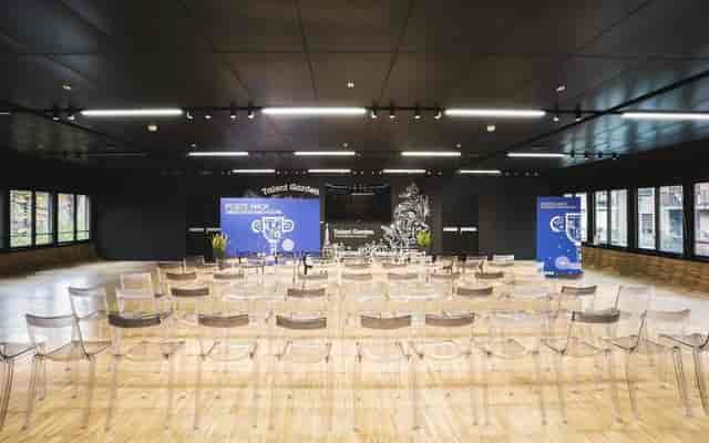 Modern meeting room with acrylic chairs set for a presentation in Talent Garden Copenhagen.